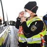 A female federal police officer puts on a breathing mask at the border crossing to Switzerland before an inspection in Weil am Rhein, on March 16, 2020. In the wake of the coronavirus crisis, Germany will introduce comprehensive controls and entry bans at its borders with Switzerland.