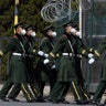 Chinese paramilitary wearing masks march by during their duty in an embassy district in Beijing on March 16, 2020.