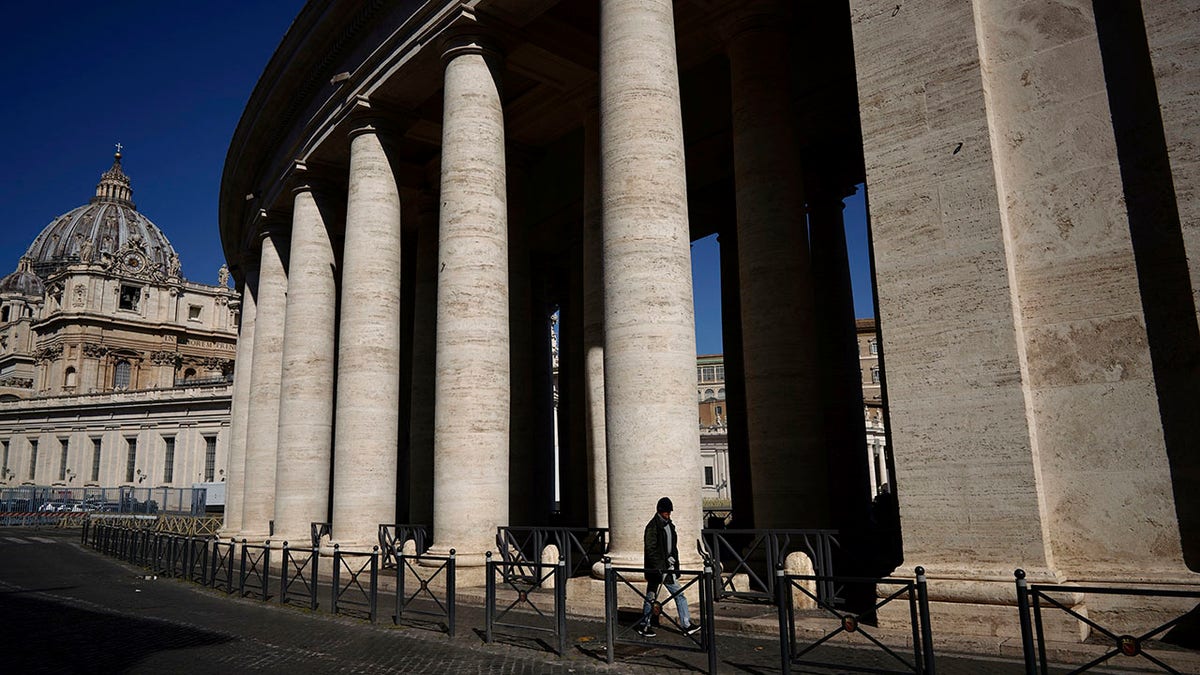 A man walks by Bernini's colonnade in St. Peter's Square during Pope Francis' weekly general audience, streamed by the Vatican television due to restrictions to contain the Covid-19 virus, at the Vatican, Wednesday, April 1, 2020. (Associated Press)