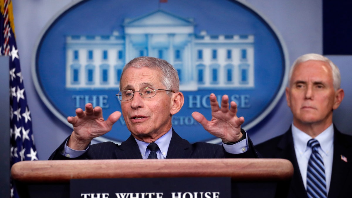 Dr. Anthony Fauci, director of the National Institute of Allergy and Infectious Diseases, speaks about the coronavirus at the White House, April 1, 2020, as Vice President Mike Pence listens. (Associated Press)