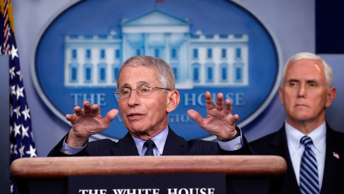 Dr. Anthony Fauci, director of the National Institute of Allergy and Infectious Diseases, speaks about the coronavirus in the James Brady Press Briefing Room of the White House, Wednesday, April 1, 2020, in Washington, as Vice President Mike Pence listens. (AP Photo/Alex Brandon)