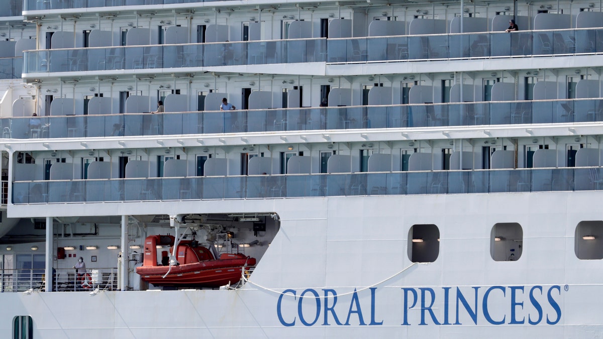 People look out from the Coral Princess cruise ship as it is docked at PortMiami during the new coronavirus outbreak on April 4. (AP Photo/Lynne Sladky)