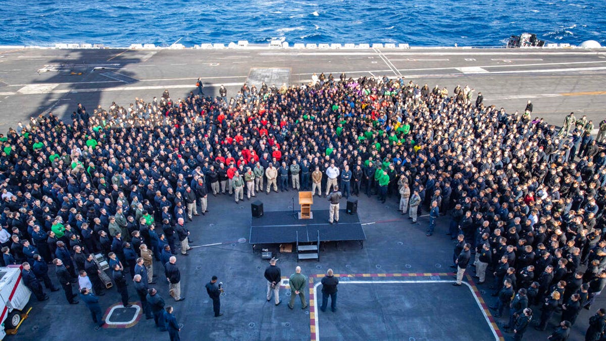 FILE - In this Dec. 15, 2019, file photo, U.S.Navy Capt. Brett Crozier, commanding officer of the aircraft carrier USS Theodore Roosevelt (CVN 71), addresses the crew during an all hands call on the ship's flight deck while conducting routine training in the Eastern Pacific Ocean.. (U.S. Navy Photo by Mass Communication Specialist Seaman Kaylianna Genier via AP)