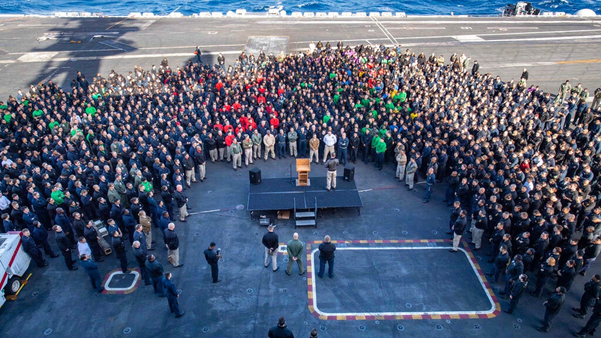 FILE - In this Dec. 15, 2019, file photo, U.S.Navy Capt. Brett Crozier, commanding officer of the aircraft carrier USS Theodore Roosevelt (CVN 71), addresses the crew during an all hands call on the ship's flight deck while conducting routine training in the Eastern Pacific Ocean.. (U.S. Navy Photo by Mass Communication Specialist Seaman Kaylianna Genier via AP)
