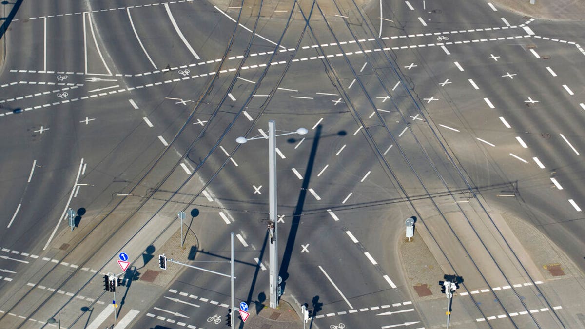 No vehicles or passers-by are visible at an intersection on the Grimmaischen Steinweg in Leipzig, Germany, Tuesday, April 7, 2020.