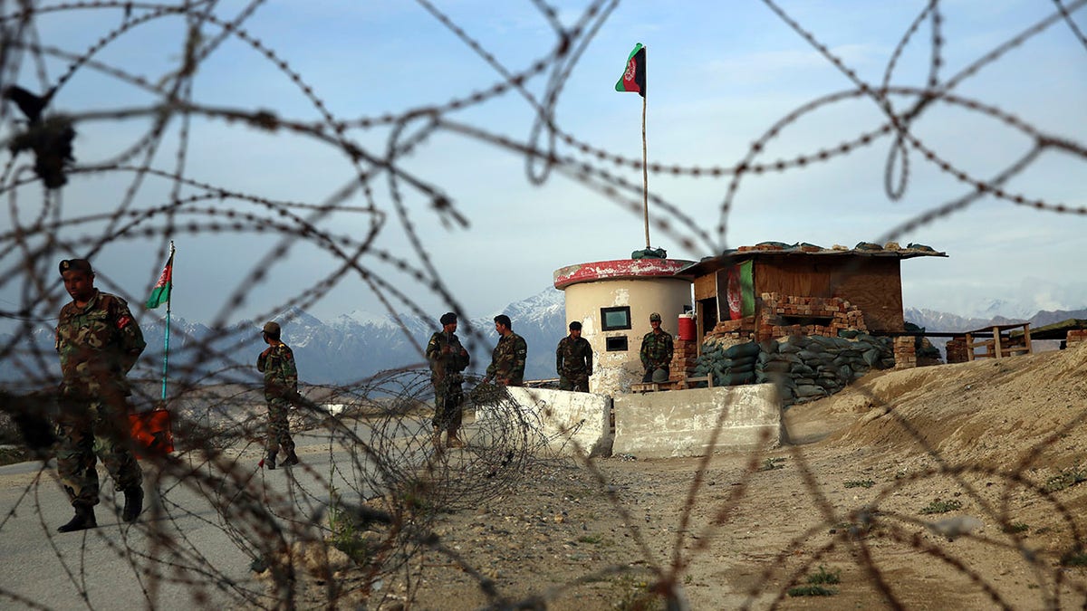 Afghan National Army soldiers stand guard at a checkpoint near the Bagram base in northern Kabul, Afghanistan, Wednesday, April 8, 2020. (AP Photo/Rahmat Gul)