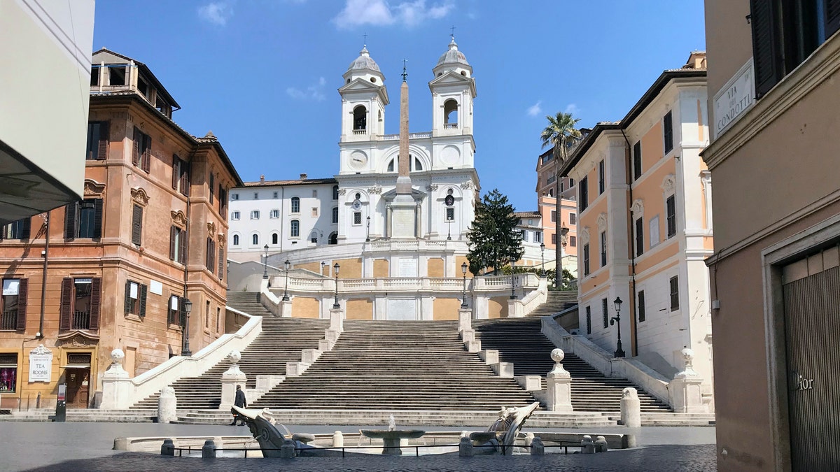 A view of the empty Piazza di Spagna, at the foot of the Spanish Steps, following the coronavirus lockdown measures, in Rome, Thursday. The new coronavirus causes mild or moderate symptoms for most people, but for some, especially older adults and people with existing health problems, it can cause more severe illness or death. (AP Photo/Karl Ritter)