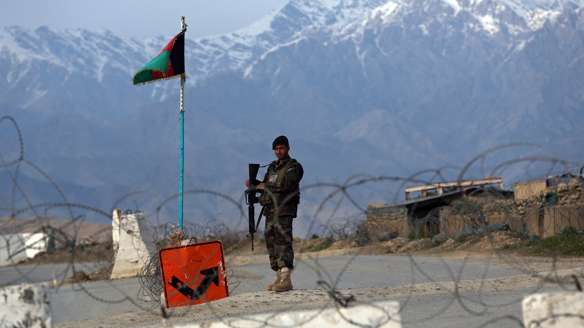 An Afghan National Army soldier stands guard at a checkpoint near the Bagram base north of Kabul, Afghanistan on April 8. A wave of Taliban attacks on checkpoints across Afghanistan has killed 29 members of the security forces, officials said Monday. (AP Photo/Rahmat Gul, File)