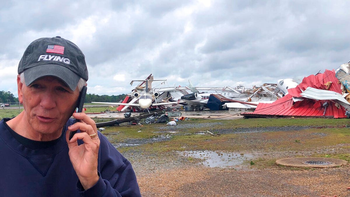 Rep. Ralph Abraham seen talking on his phone in front of a destroyed hangar and damaged planes at Monroe Regional Airport in Monroe, La.