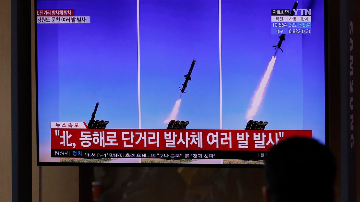 People watch a TV screen airing reports about North Korea's firing missiles with file images of missiles at the Seoul Railway Station in Seoul, South Korea, Tuesday, April 14, 2020. South Korea says North Korean fighter jets have fired missiles off the North's east coast. \(AP Photo/Lee Jin-man)