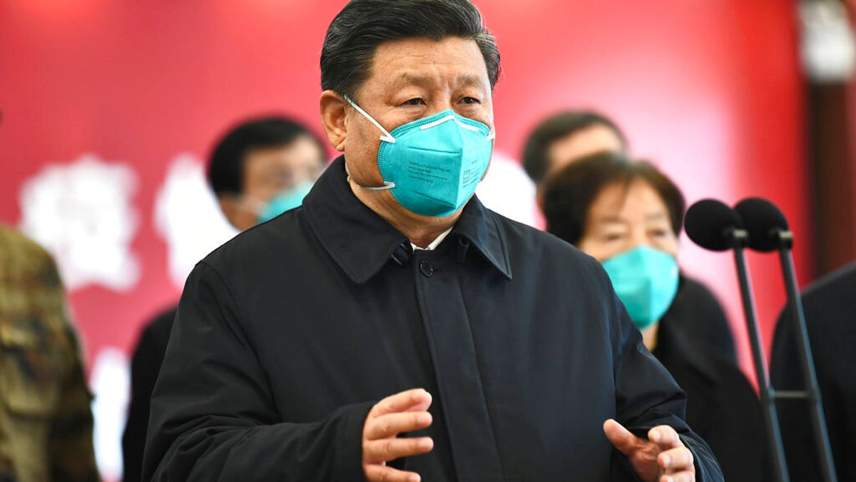 In this Tuesday, March 10, 2020, photo released by China's Xinhua News Agency, Chinese President Xi Jinping talks by video with patients and medical workers at the Huoshenshan Hospital in Wuhan in central China's Hubei Province. (Xie Huanchi/Xinhua via AP)