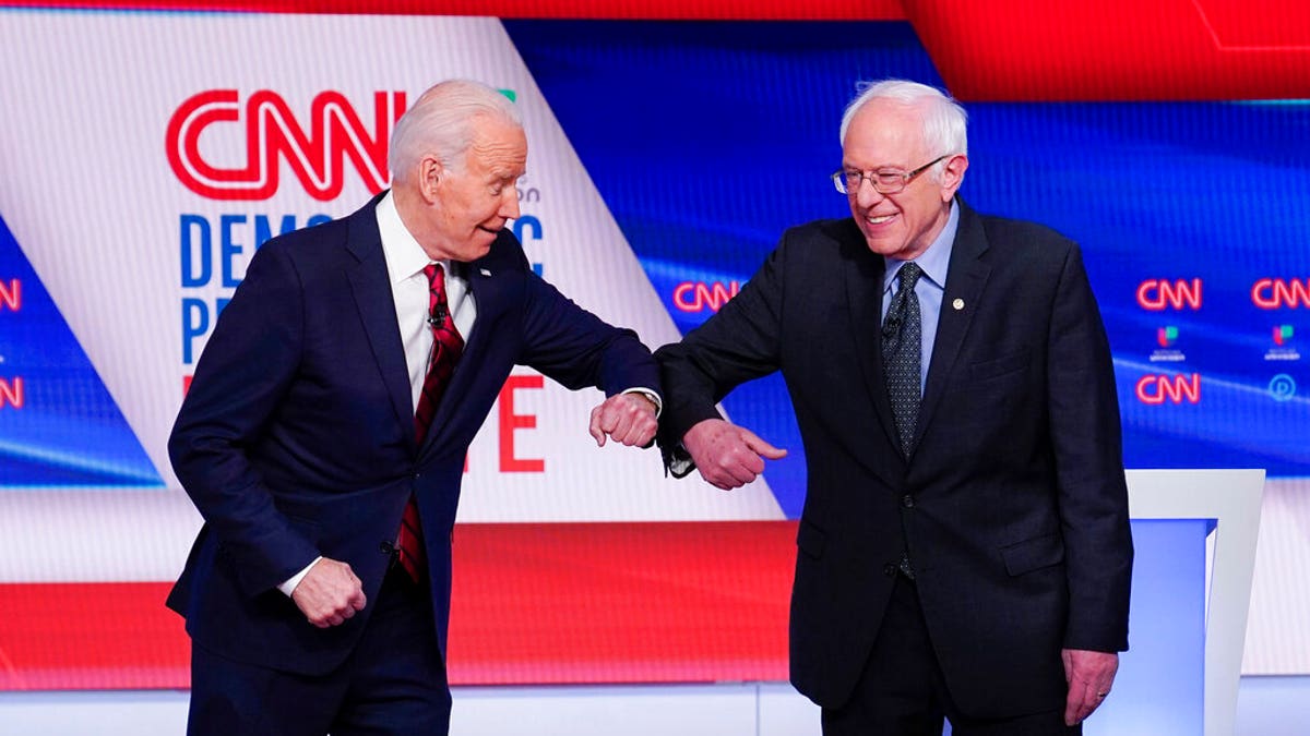 March 15, 2020: Former Vice President Joe Biden, left, and Sen. Bernie Sanders, I-Vt., right, greet one another before they participate in a Democratic presidential primary debate at CNN Studios in Washington. Sanders said Tuesday that it would be “irresponsible” for his loyalists not to support Joe Biden, warning that progressives who “sit on their hands” in the months ahead would simply enable President Donald Trump’s reelection (AP Photo/Evan Vucci)