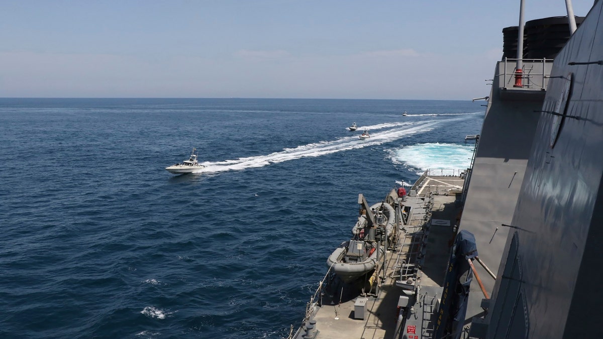 Iranian Revolutionary Guard vessels sail close to U.S. military ships in the Persian Gulf near Kuwait on April 15, 2020.  (U.S. Navy via AP)