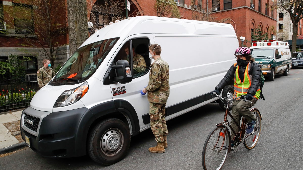 National Guard members arrive at Cobble Hill Health Center April 17, in the Brooklyn borough of New York. (AP Photo/John Minchillo)