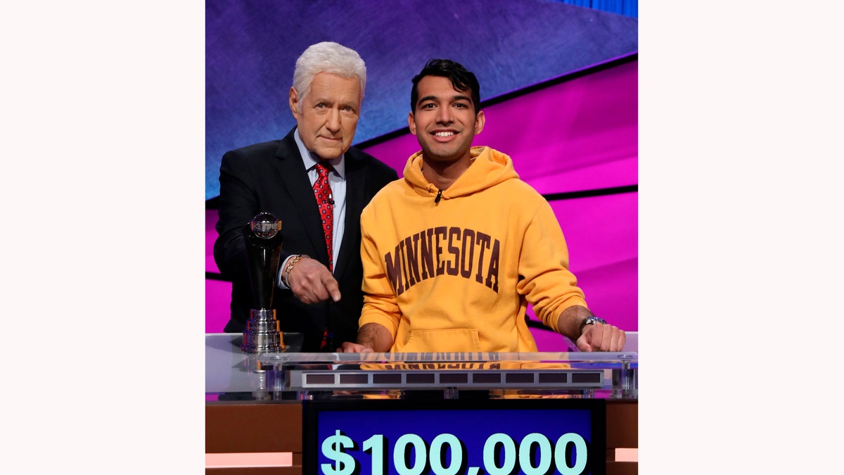 This image released by Jeopardy Productions, Inc. shows host Alex Trebek and Nibir Sarma, a sophomore from Eden Prairie, Minn. 