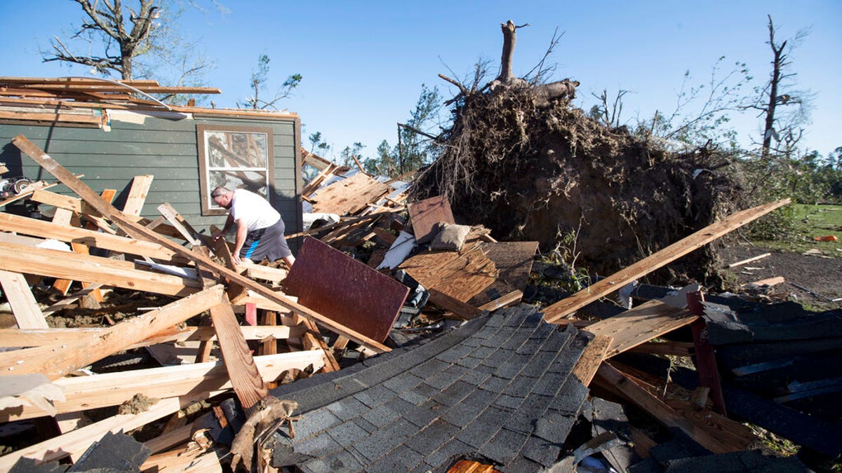 David Maynard sifts through the rubble searching for his wallet, Thursday, April 23, 2020 in Onalaska, Texas, after a tornado destroyed his home the night before. Maynard was inside his home when a tornado devastated the area. 