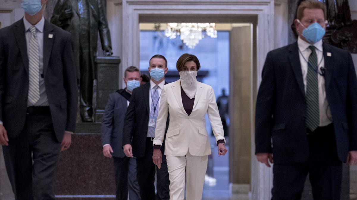 House Speaker Nancy Pelosi of Calif. walks to the House Chamber to vote on the nearly $500 billion Coronavirus relief bill on Capitol Hill, Thursday, April 23, 2020, in Washington. (AP Photo/Andrew Harnik)