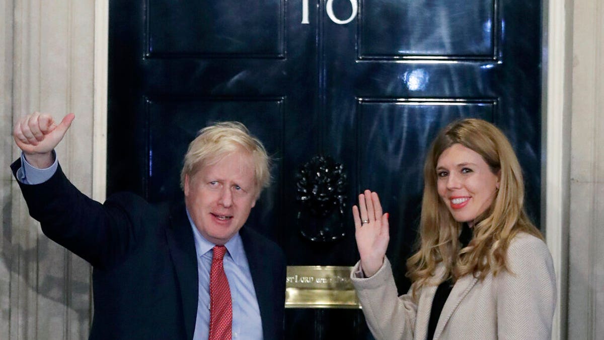 <br>
Britain's Prime Minister Boris Johnson and his partner Carrie Symonds wave from the steps of No. 10 Downing Street in London, Dec. 13, 2019. (Associated Press)