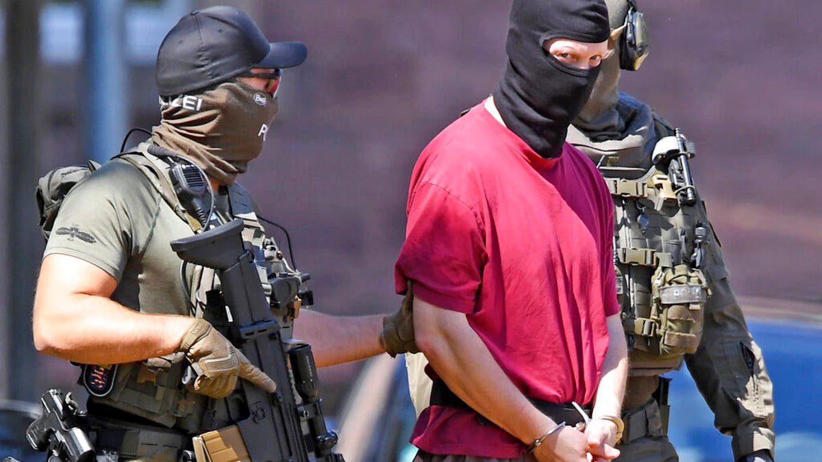 FILE: Suspect Stephan E., center, is escorted to a helicopter in Karlsruhe, Germany.
