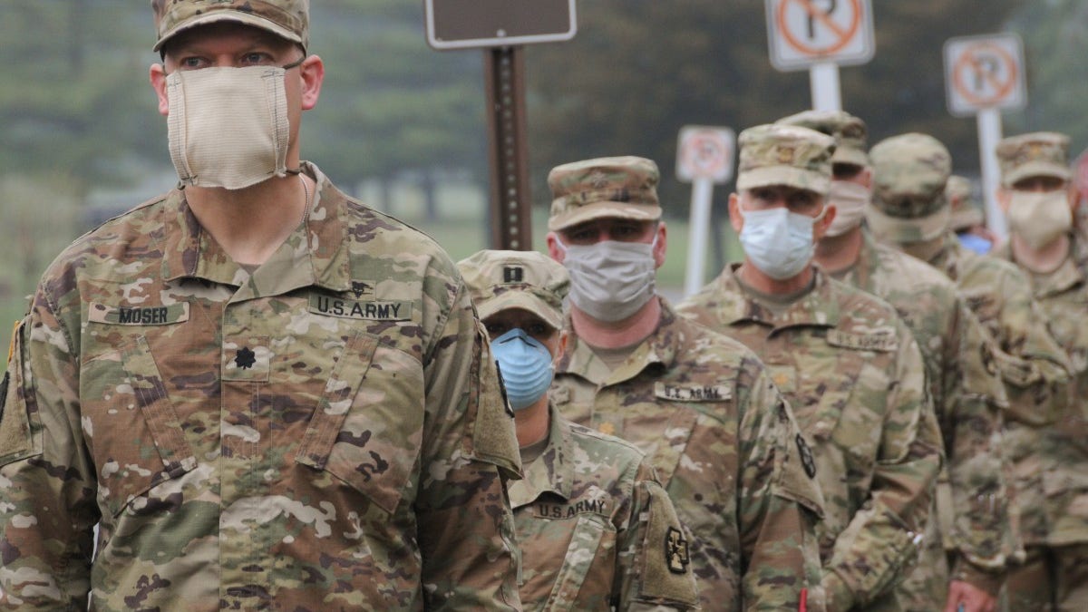 U.S. Army Reserve Urban Augmentation Medical Task Force Soldiers prepare to board buses at Joint Base McGuire-Dix-Lakehurst, New Jersey, to deploy to community hospitals, April 08, 2020.