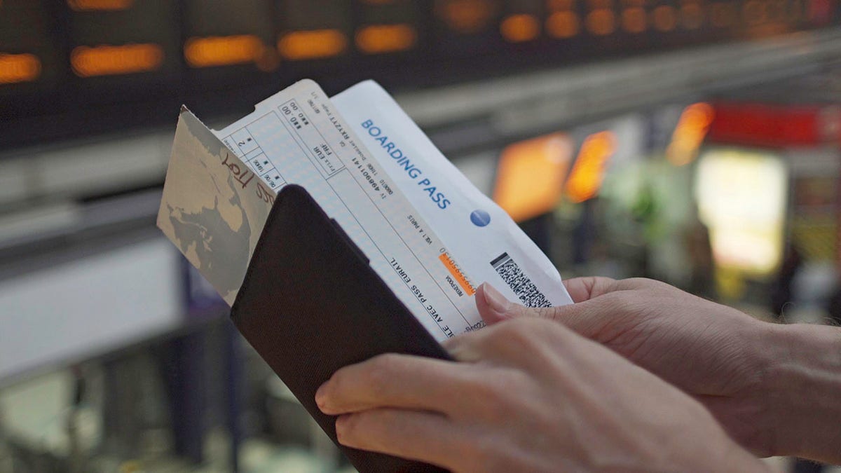 Hands holding travel documents