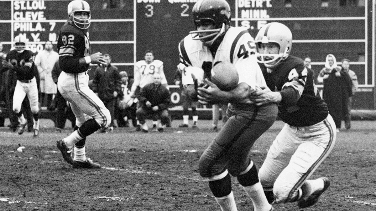 Bobby Mitchell of the Washington Redskins making a catch while Pittsburgh Steelers defensive back Bill Daniels, during a 1962 game in Pittsburgh.