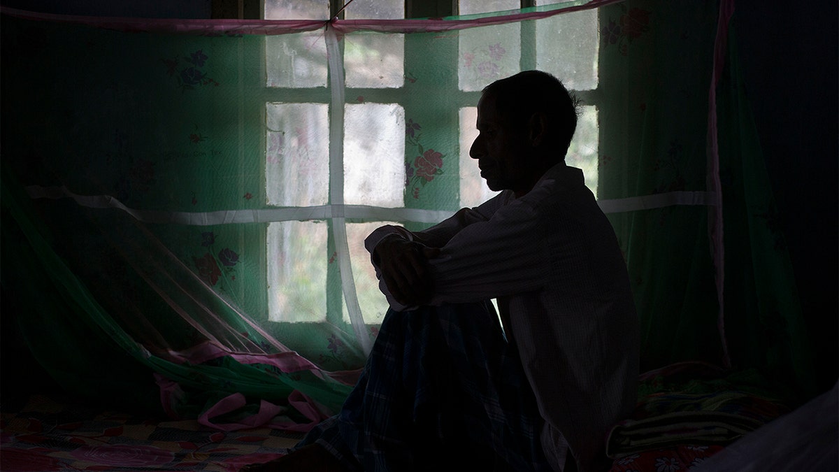 FILE- In this March 24, 2018, file photo, a tuberculosis patient sits on a bed at a TB hospital in Gauhati, India.  (AP Photo/Anupam Nath, File)