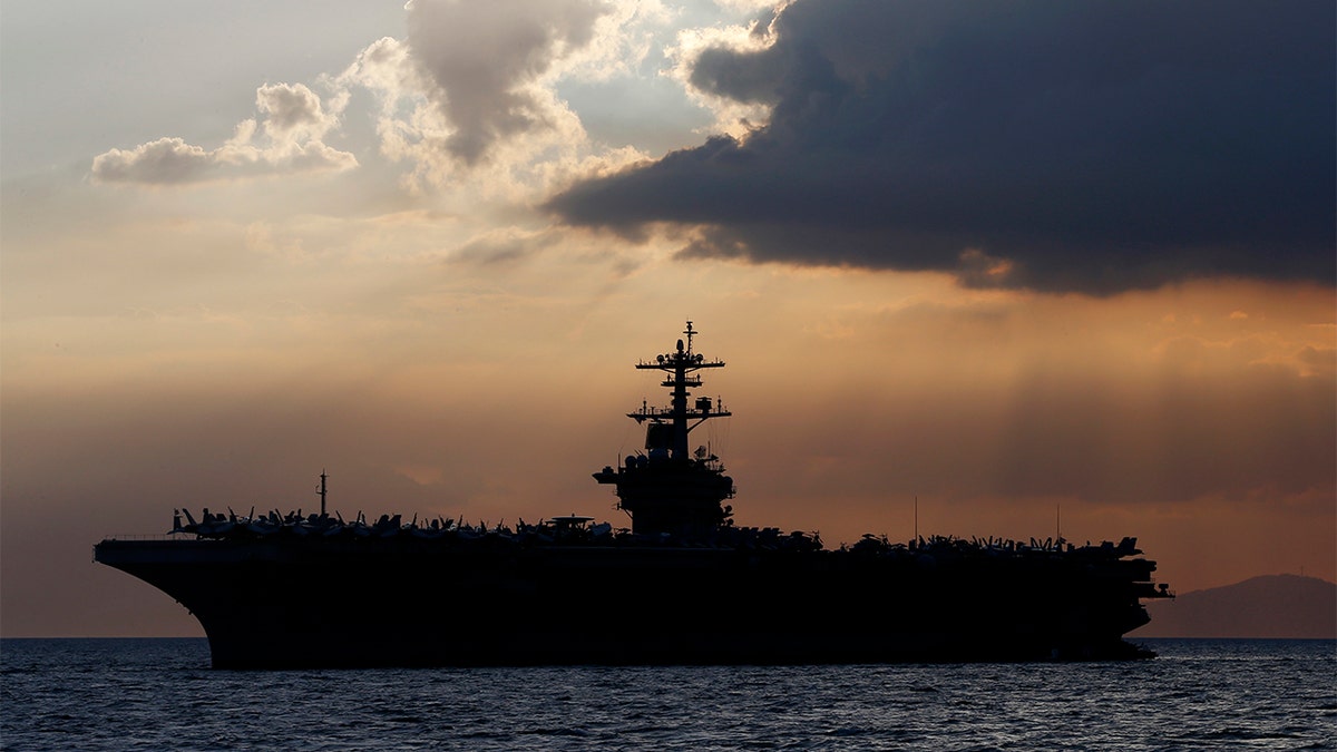 FILE - In this April 13, 2018, file photo the USS Theodore Roosevelt aircraft carrier is anchored off Manila Bay west of Manila, Philippines. (AP Photo/Bullit Marquez, File)