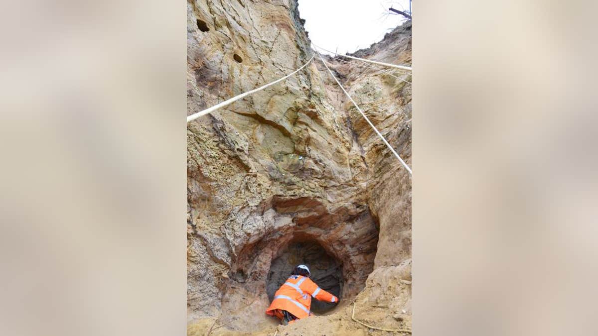 Archaeologists abseiled to the cave. (Archaeology South-East)