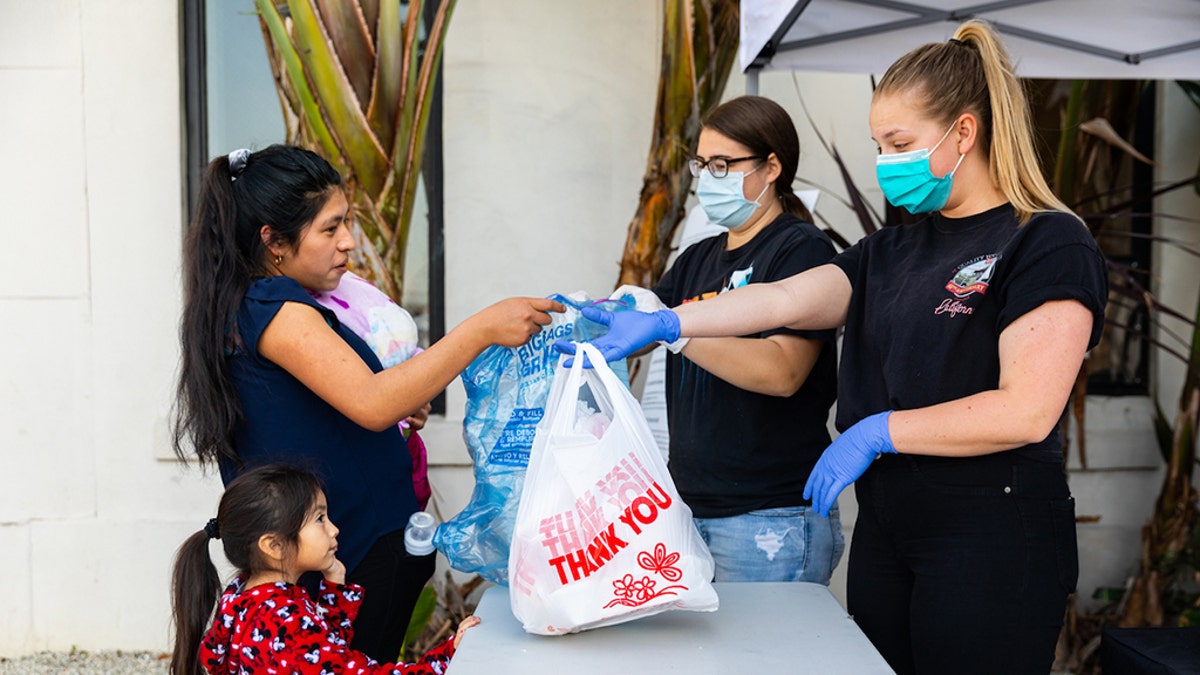 Volunteers at the LA Dream Center hand out meals and essential items.