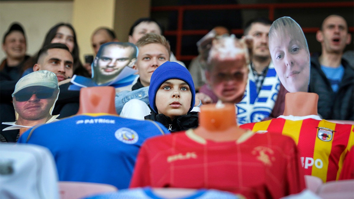 In this photo taken on Wednesday, April 8, 2020, fans sit in the stands among mannequins in soccer uniforms with the faces of "virtual fans" who bought tickets online during the match between FC Dynamo Brest and FC Shakhter Soligorsk in Brest, Belarus. (Alexey Komelkov, FC Dynamo Brest via AP)