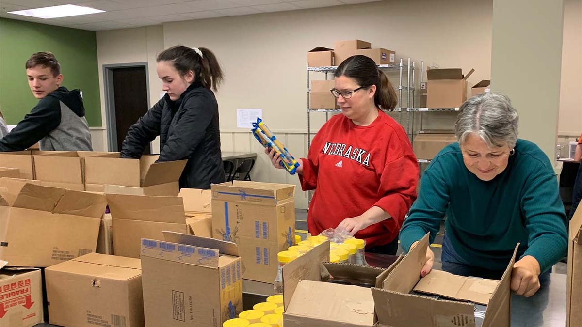 Volunteers at Food Bank of the Heartland pack coronavirus emergency boxes. (Feeding America)
