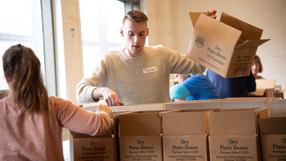 Volunteers at Food Bank of the Southern Tier in Upstate New York packing emergency food boxes and bagging produce for drop and go delivery at Mobile Food Pantry sites and for distribution through regional school districts. (Feeding America)