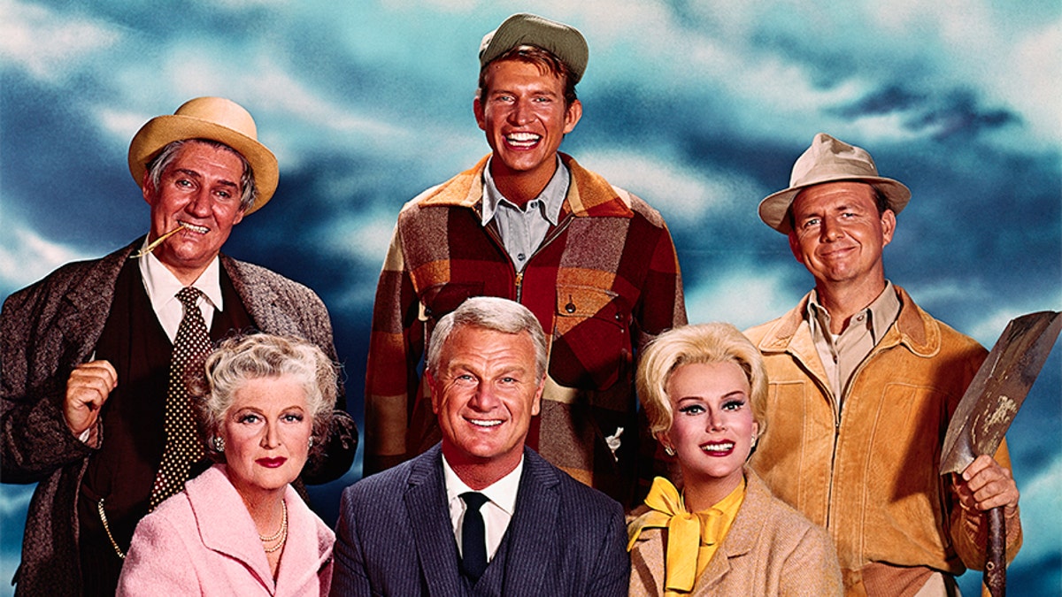Publicity photo of the cast of 'Green Acres' left to right: Pat Buttram as Mr. Haney, Tom Lester as Eb Dawson, Alvy Moore as Hank Kimball, (seated) Eleanor Audley as Eunice Douglas, Eddie Albert as Oliver Douglas and Eva Gabor as Lisa Douglas.