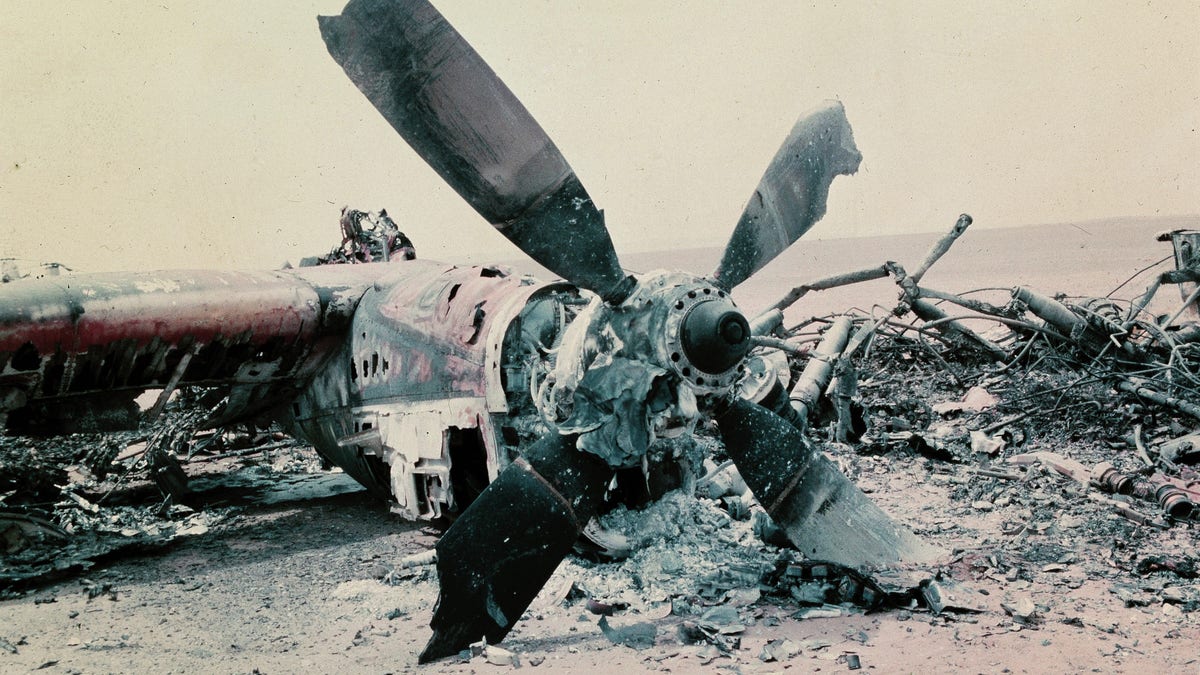 The burned out wreckage of a U.S. aircraft lies in the desert some 300 miles south of Tehran after the abortive commando-style raid into Iran, April 1980, aimed at freeing the American hostages being held in Tehran. The rescue mission fell apart when several helicopters failed and a helicopter and C141 transport plane collided. At least 8 U.S. servicemen died in the mission. (AP Photo)