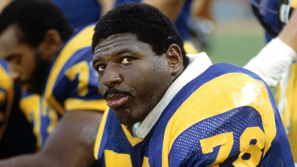 Offensive tackle Jackie Slater #78 of the Los Angeles Rams sits on the bench during a football game at Anaheim Stadium in Anaheim, California. Slater played for the Rams from 1976-95. (Photo by Andrew D. Bernstein/Getty Images)
