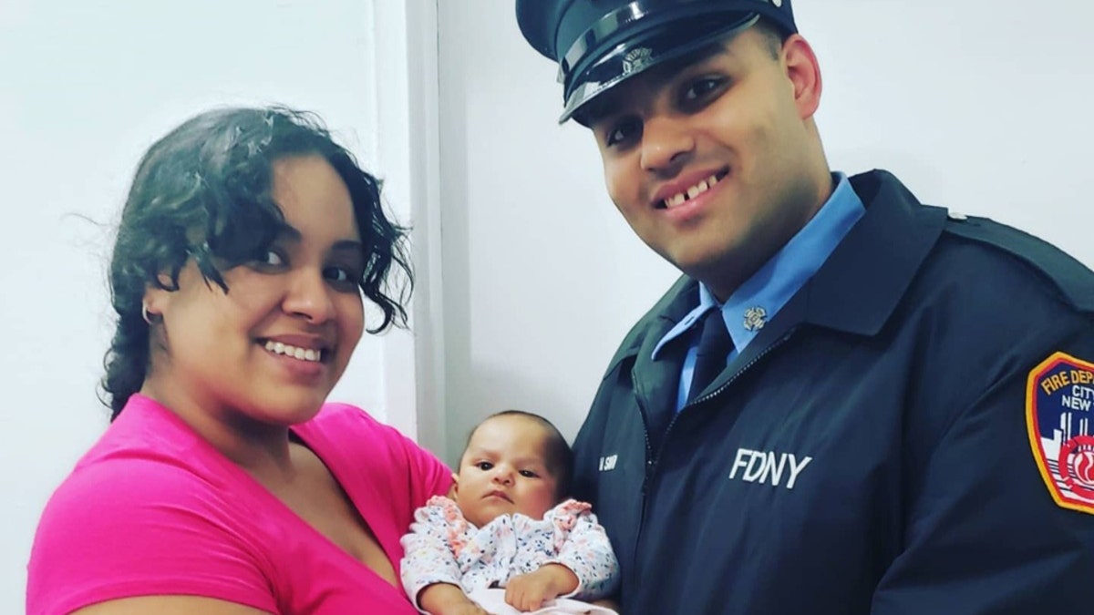 FDNY firefighter Jerel La Santa and Lindsey Mahala with Jay-Natalie.