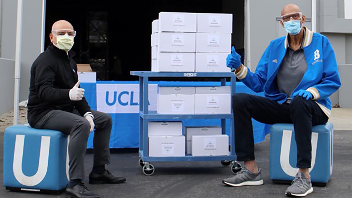 UCLA’s Dr. Eric Esrailian, left, accepted the donation of goggles on behalf of UCLA Health from Kareem Abdul-Jabbar on April 7, 2020.