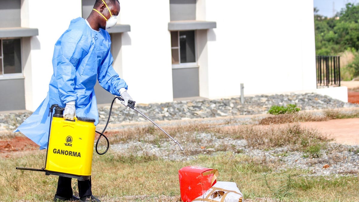 A laboratory staff disinfects box carrying COVID-19 test samples that were delivered via drone.