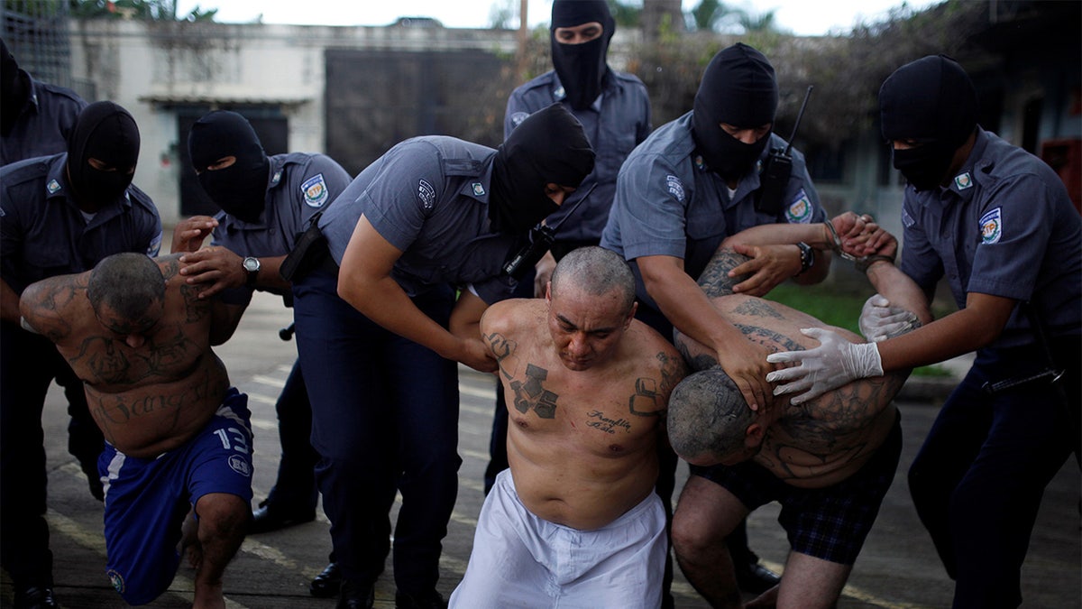 Mara Salvatrucha, or MS-13, gang members wait to be escorted upon their arrival at the maximum-security jail in Zacatecoluca, El Salvador, Oct. 12, 2017.