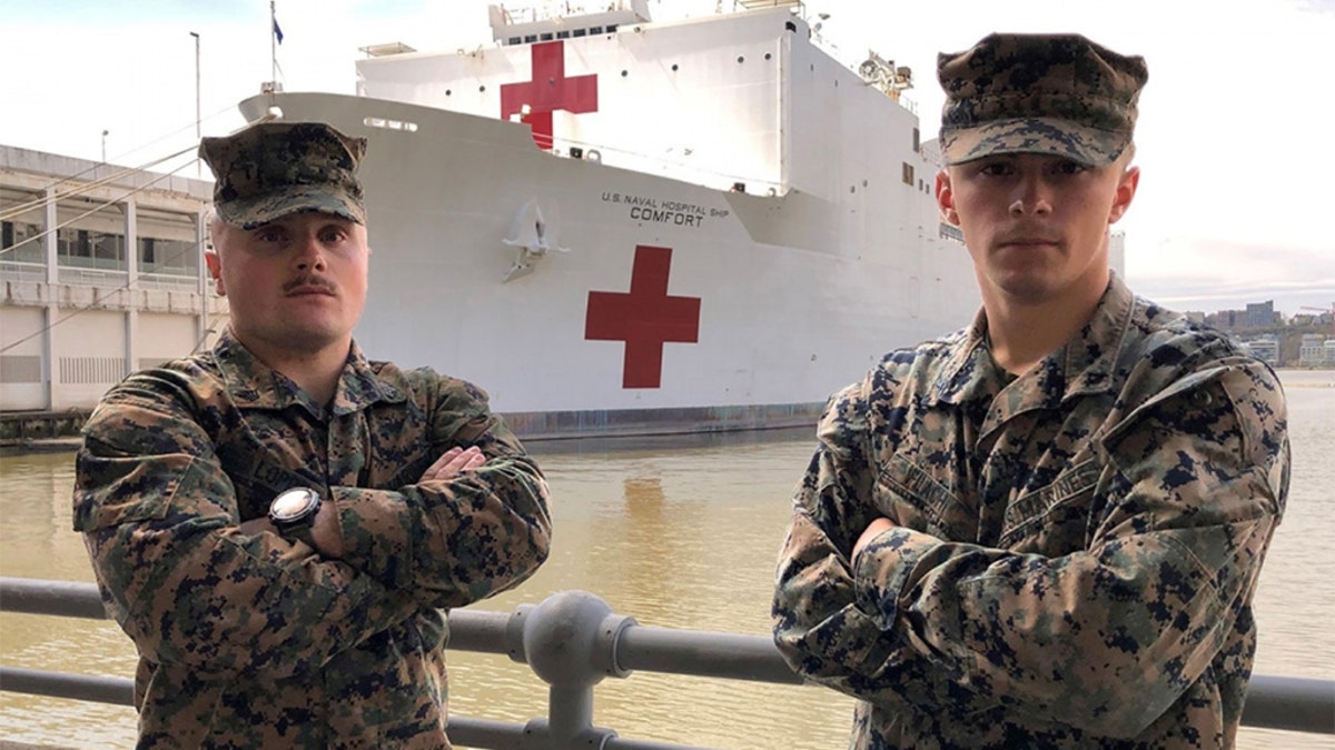 U.S. Marine Sgt. Austin Loppe, left, and U.S. Marine Lance Cpl. Colton Flach, right, are assigned to II Marine Expeditionary Force as part of a Marine security detachment supporting the USNS Comfort. (U.S. Navy photo by Ensign James Caliva)