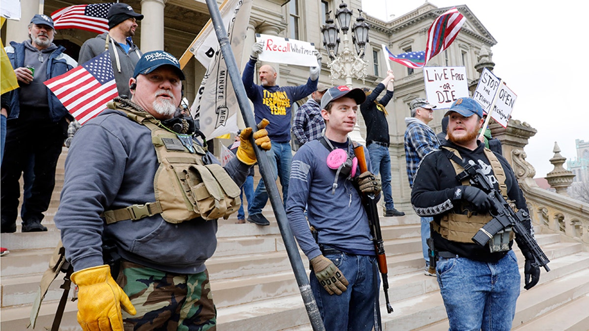 People take part in a protest for "Michiganders Against Excessive Quarantine" at the Michigan State Capitol in Lansing, Michigan on April 15, 2020. - The group is upset with Michigan Governor Gretchen Whitmer's(D-MI) expanded the states stay-at-home order to contain the spread of the coronavirus. (Photo by JEFF KOWALSKY/AFP via Getty Images)