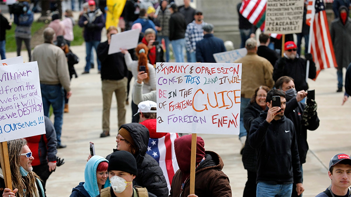 People protest against excessive quarantine amid the coronavirus pandemic at the Michigan State Capitol in Lansing, Michigan on April 15, 2020. - The protest was organized by Michiganders Against Excessive Quarantine several days after Michigan Governor Gretchen Whitmer extended her order through April 30 and took the requirements of staying home a step further, banning crossing the street to visit with neighbors or driving to see friends, among other things mandatory closure to curtail Covid-19. (Photo by JEFF KOWALSKY / AFP) (Photo by JEFF KOWALSKY/AFP via Getty Images)