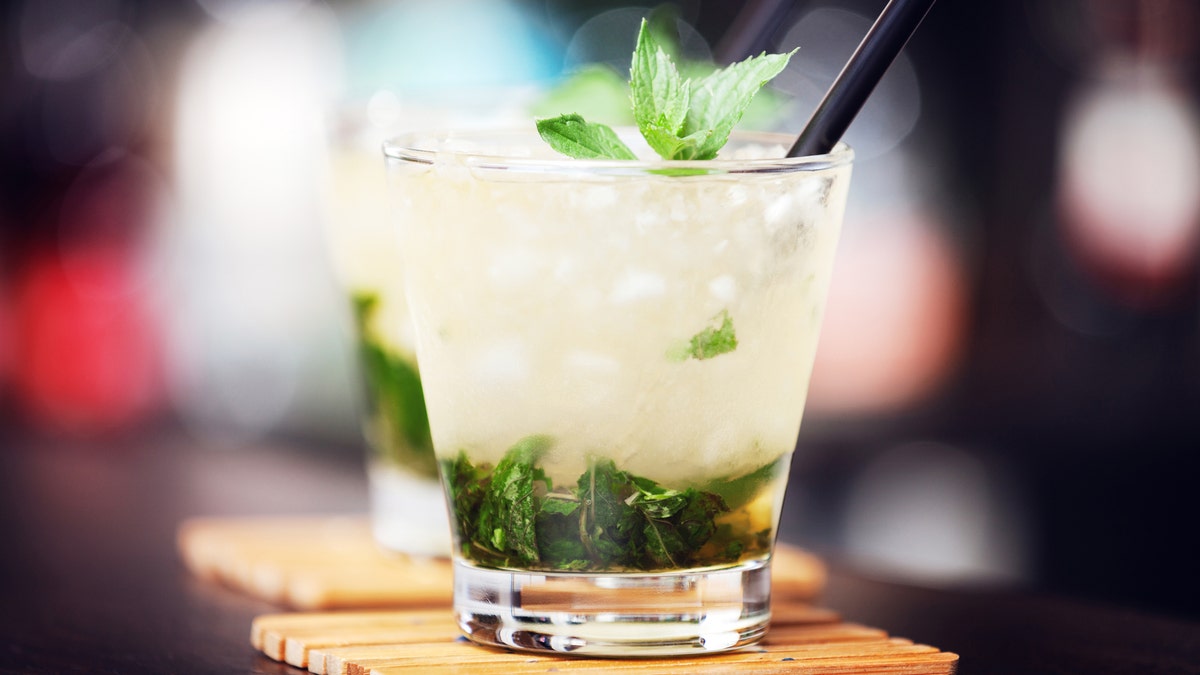 Mint julep cocktail on a coaster at a bar