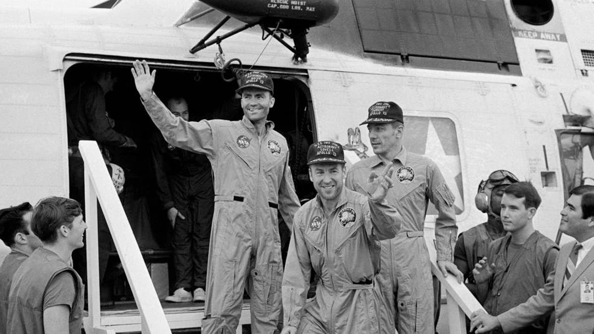 The Apollo 13 crewmembers step aboard the USS Iwo Jima, prime recovery ship for the mission, following splashdown and recovery operations in the South Pacific Ocean. Exiting the helicopter which made the pick-up some four miles from the Iwo Jima are (from left) astronauts Fred Haise, lunar module pilot; Jim Lovell., commander; and Jack Swigert, command module pilot.