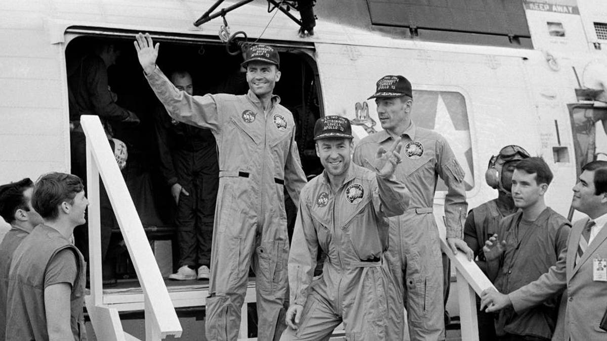 The Apollo 13 crewmembers step aboard the USS Iwo Jima, prime recovery ship for the mission, following splashdown and recovery operations in the South Pacific Ocean. Exiting the helicopter which made the pick-up some four miles from the Iwo Jima are (from left) astronauts Fred Haise, lunar module pilot; Jim Lovell., commander; and Jack Swigert, command module pilot.