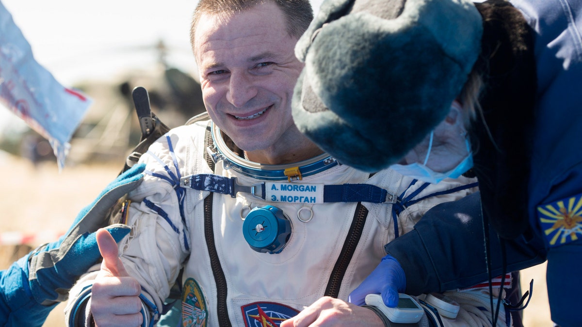 In this handout photo released by Gagarin Cosmonaut Training Centre (GCTC), Roscosmos space agency, U.S. astronaut Andrew Morgan gestures shortly after the landing of the Russian Soyuz MS-15 space capsule near Kazakh town of Dzhezkazgan, Kazakhstan, Friday, April 17, 2020.