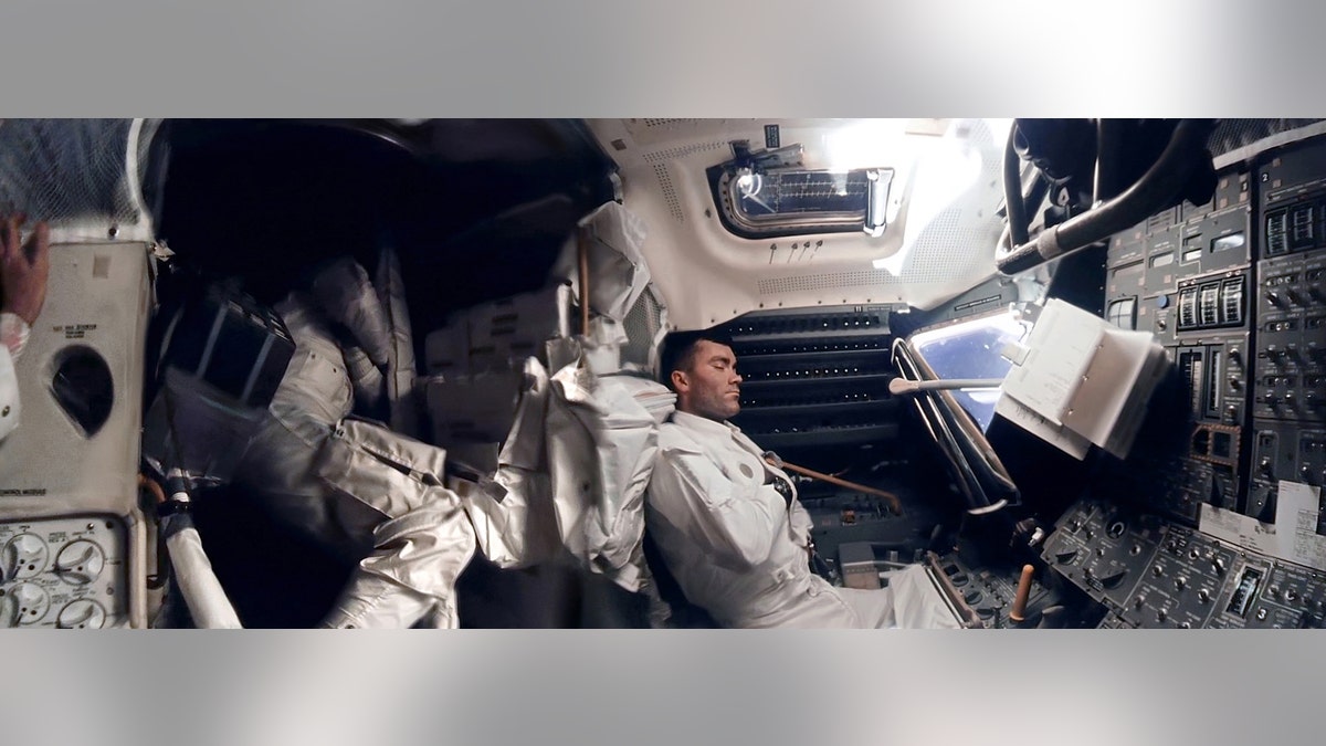 The panoramic hi-def image of interior of the Apollo 13 Lunar Module. Astronaut Fred Haise (right) is napping, while Jack Swigert can be seen curled up in the storage area. Commander Jim Lovell's hand can be seen in the left of the picture.