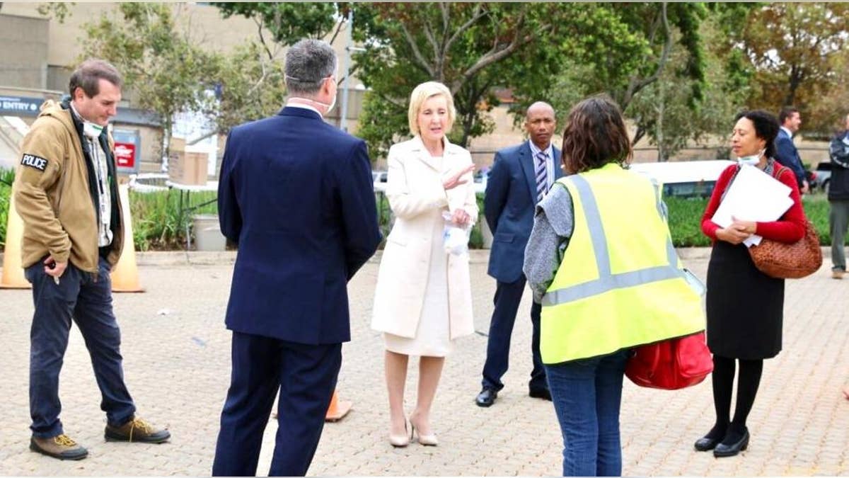 U.S. Ambassador to South Africa, Lana Marks, speaks with embassy staffers ahead of the evacuation flight of U.S. citizens in Johannesburg.