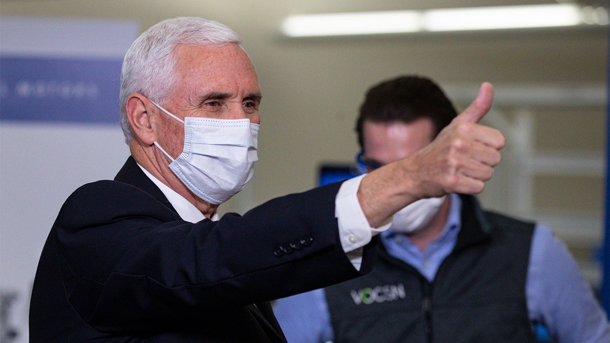 Vice President Mike Pence gestures while visiting the General Motors/Ventec ventilator production facility in Kokomo, Ind., Thursday, April 30, 2020. (AP Photo/Michael Conroy)